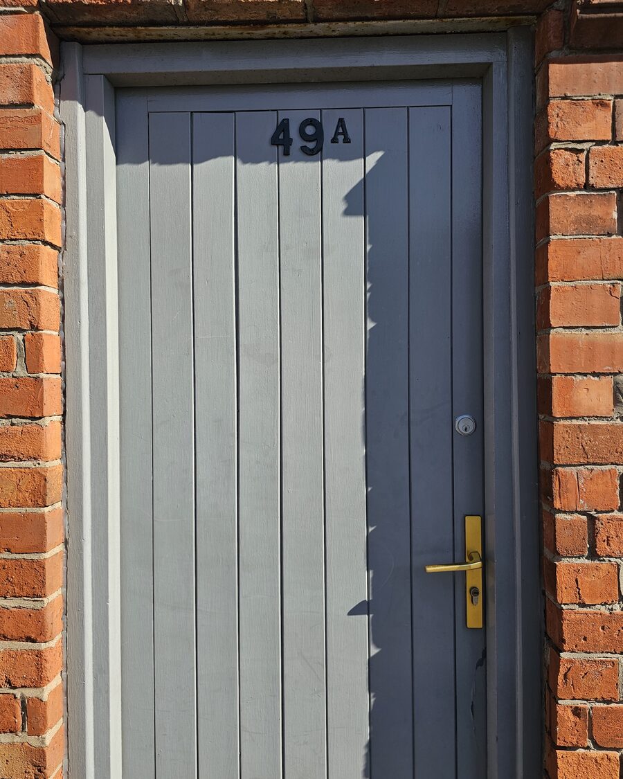 The blue 49A door on Titania Street, entrance to Barefoot Body and Soul