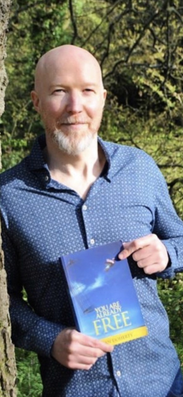 Ryan Doherty with his book You Are Already Free
